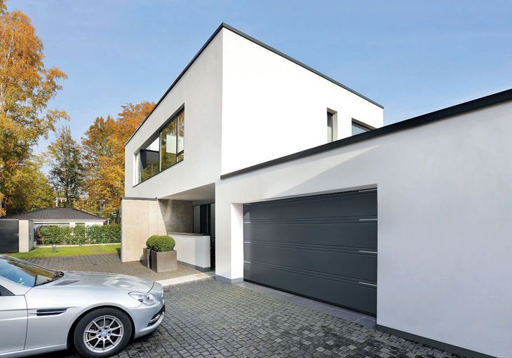 Modern house with aluminum garage door and large front windows